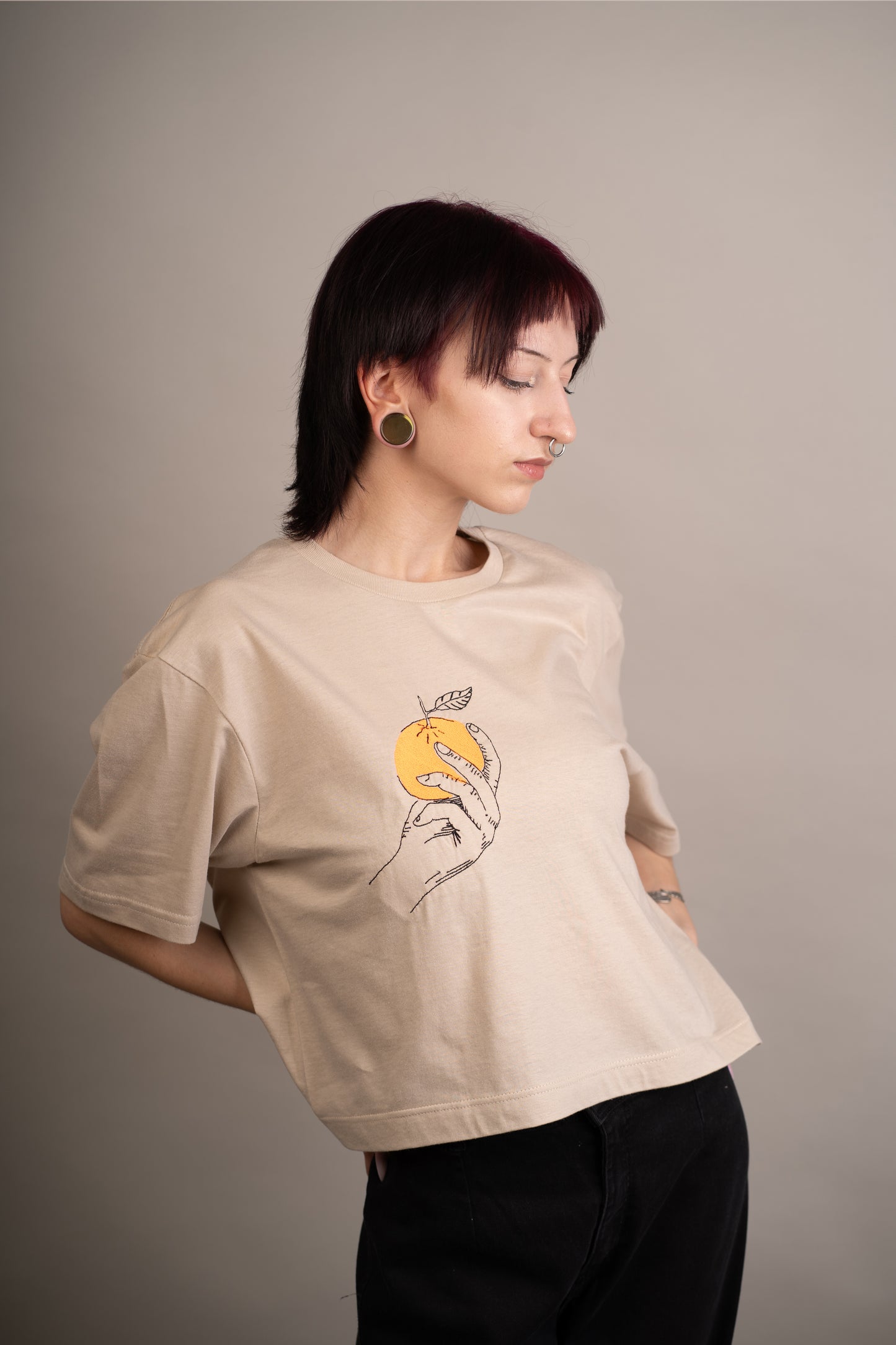 Women's graphic crop top with orange embroidery on chest