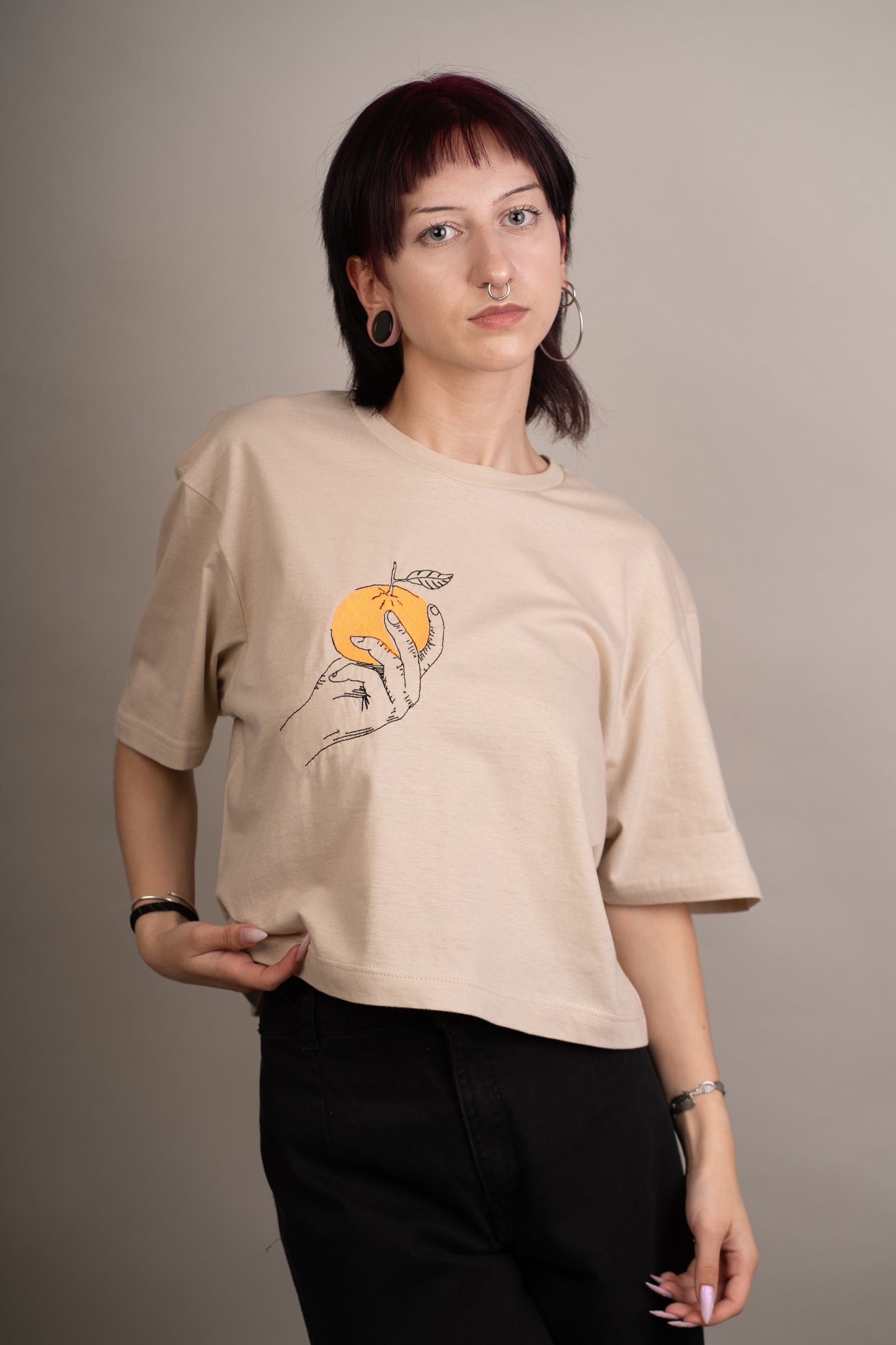 Women's graphic crop top with orange embroidery on chest