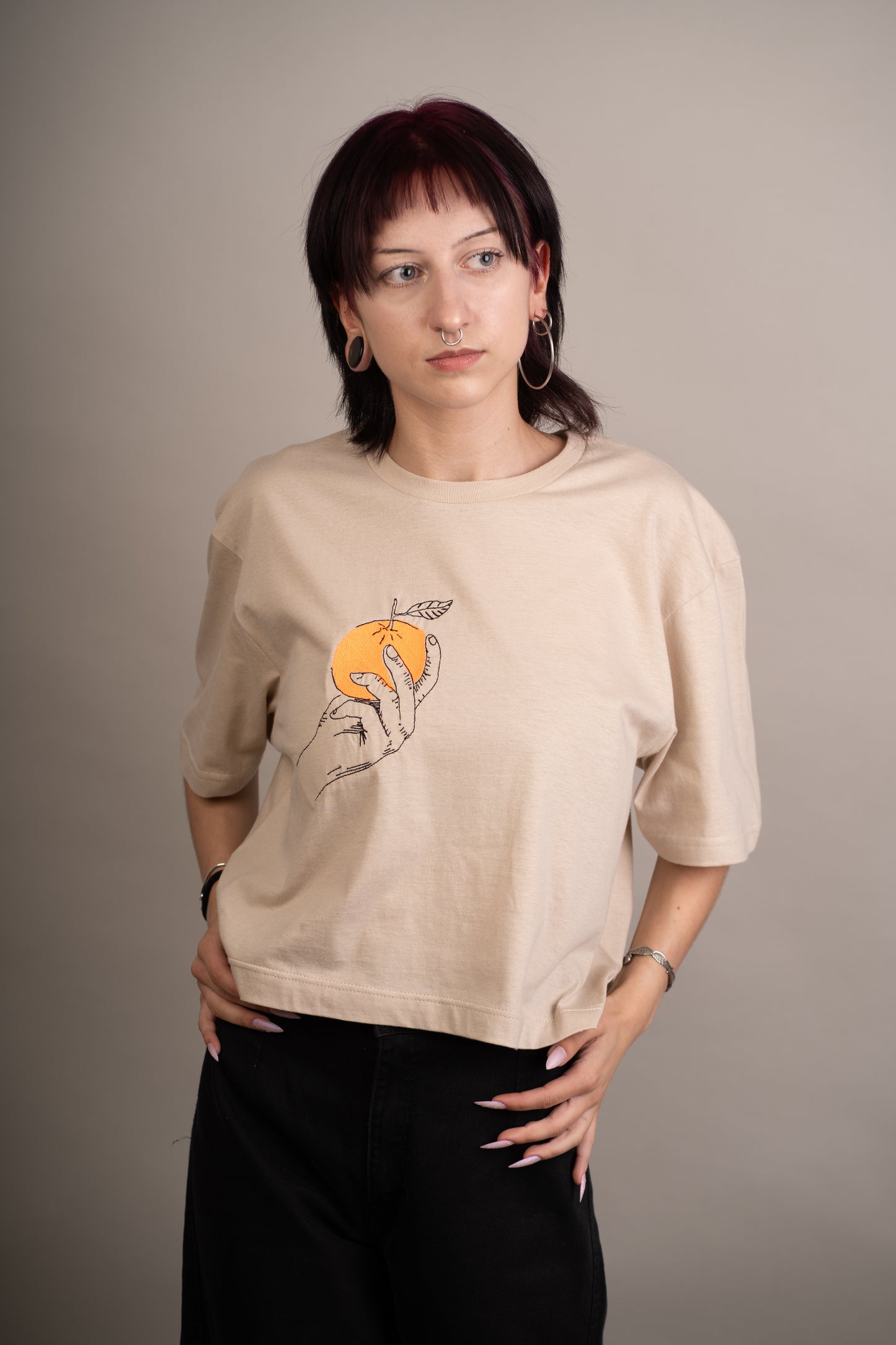 Women's graphic crop top with orange embroidery on chest