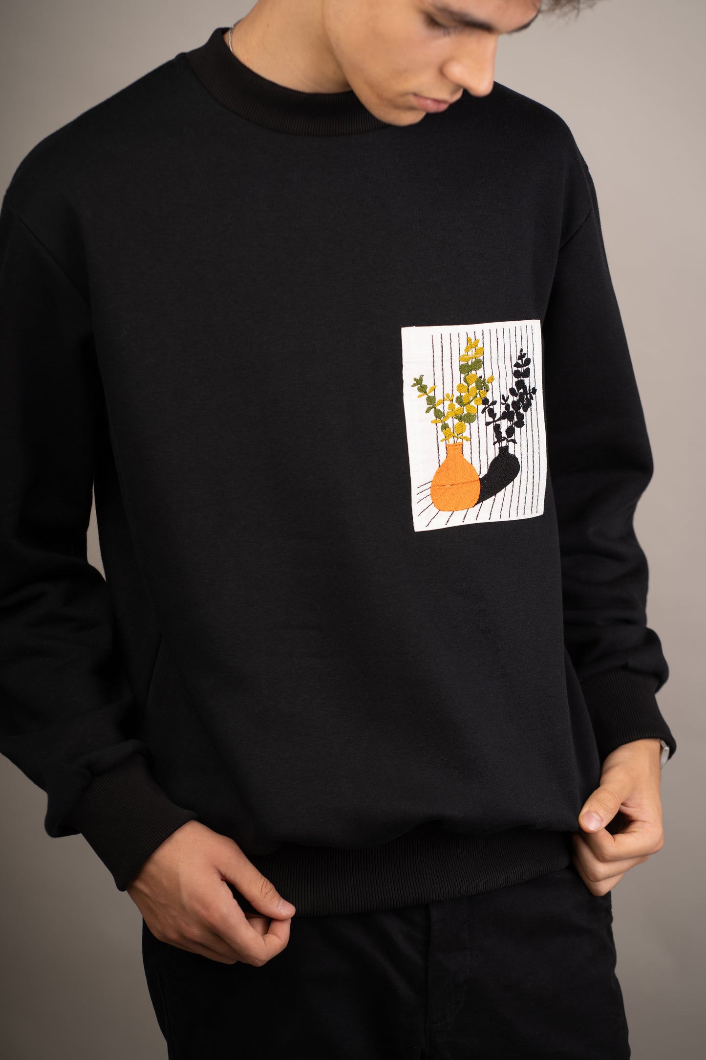 Men's black sweatshirt with still life embroidery on pocket
