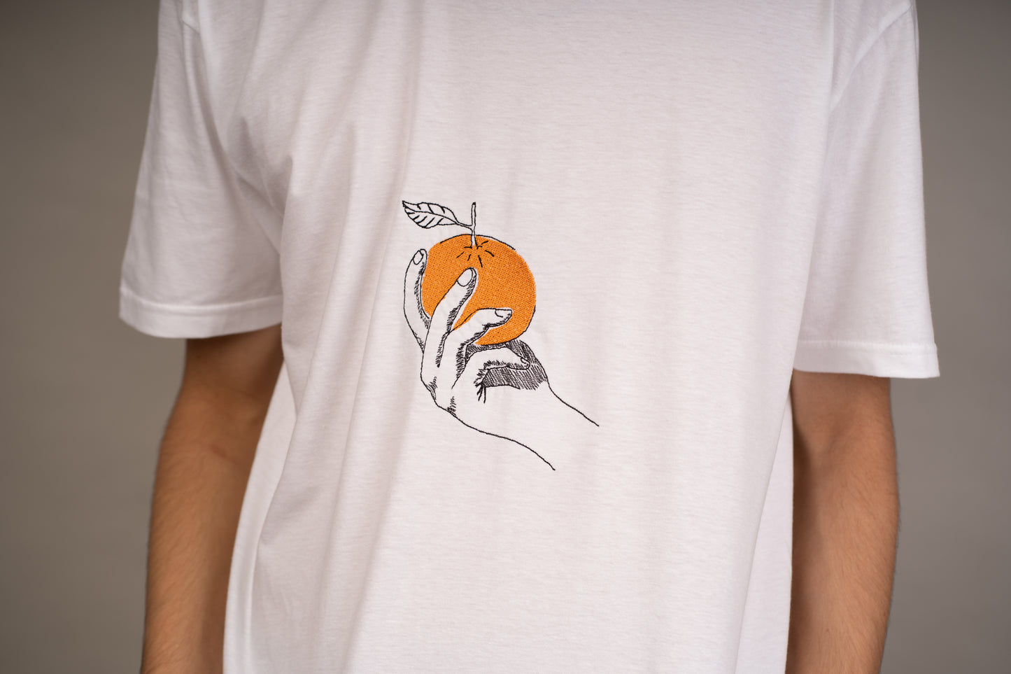 Men's graphic T-shirt with orange embroidery on chest